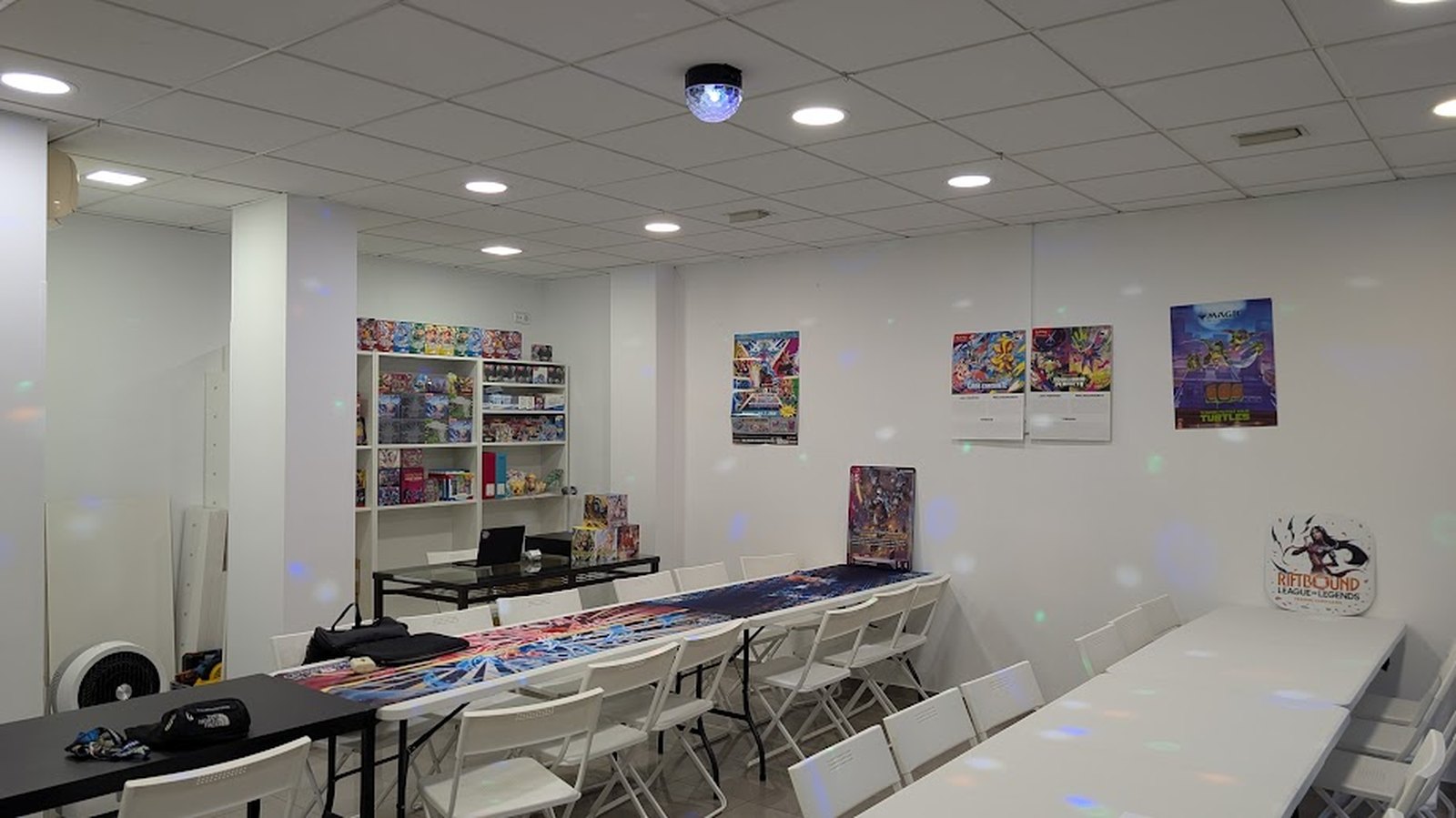 Long play tables and seating on the Spaceship TCG floor, laid out for organised play