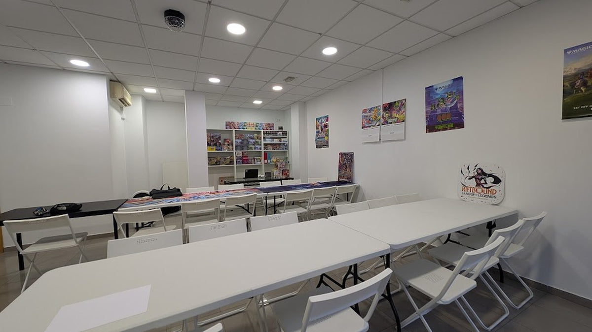 The Spaceship TCG floor in Barberà del Vallès: open tables set for play, game posters on the wall